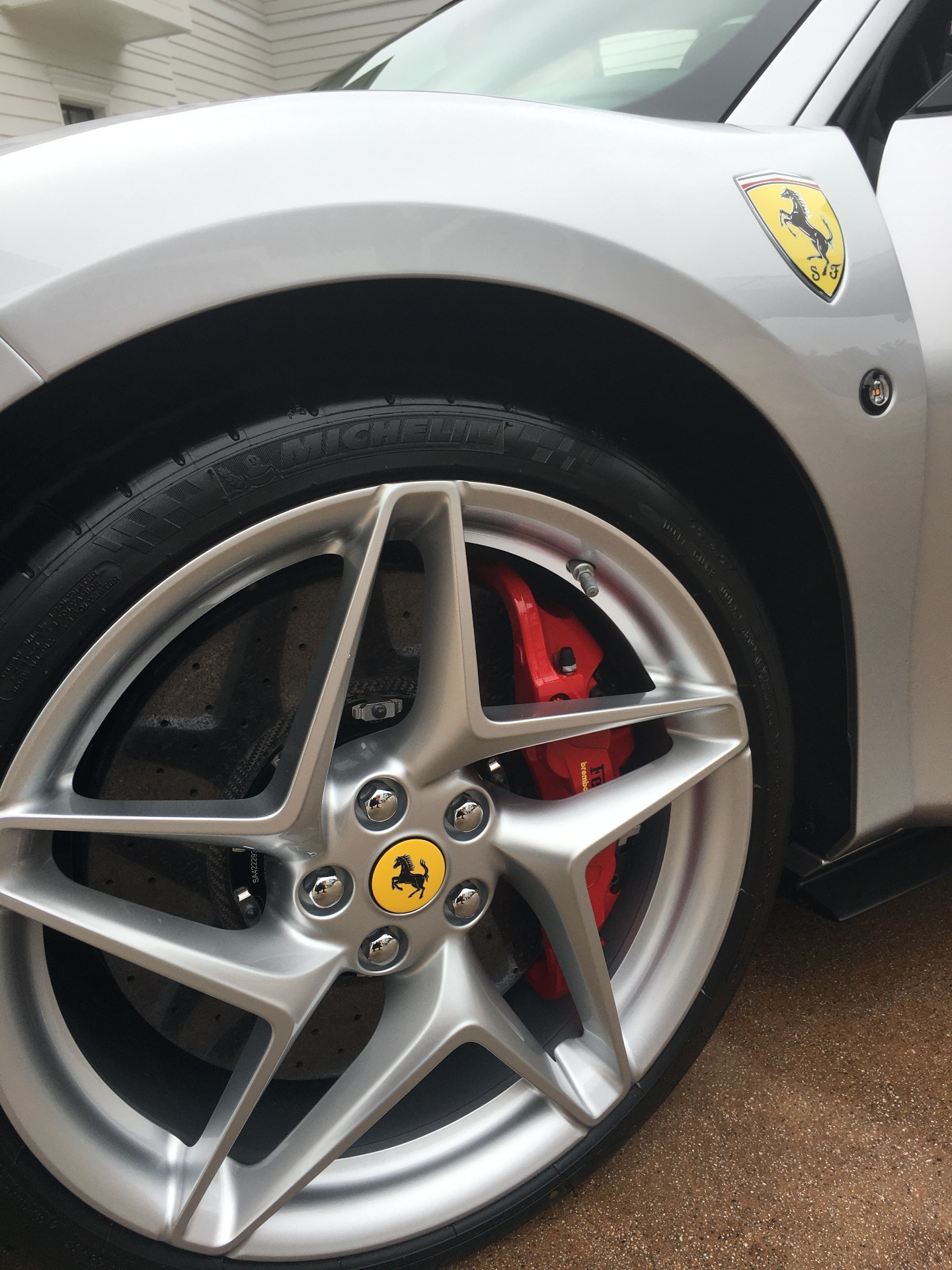 Ferrari wheel and red brake caliper close-up detail