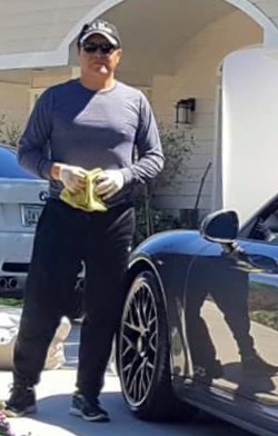 Professional detailer with luxury sports car