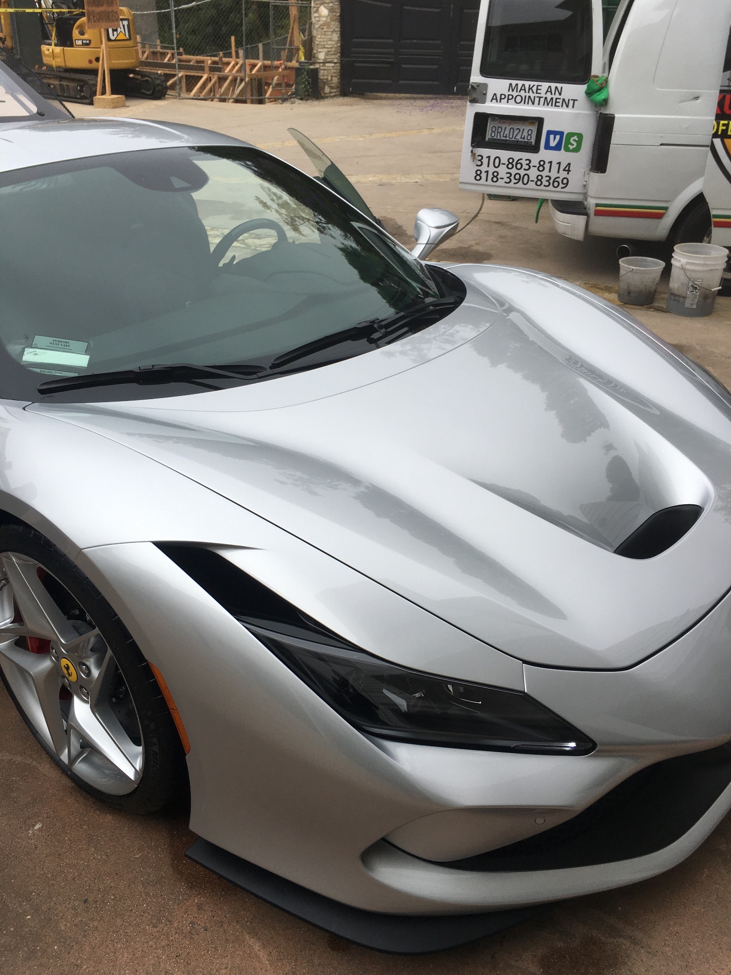 Silver Ferrari supercar front quarter view